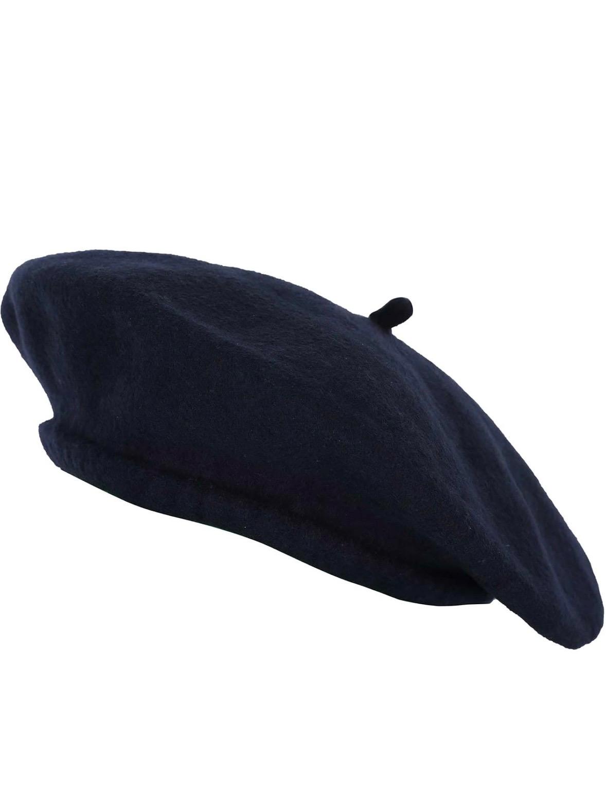 Side view of a dark navy classic beret with a small stem on top