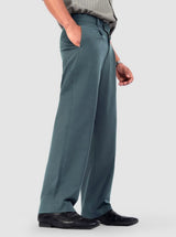 Men's teal pleated wide-leg trousers shown on a model, highlighting fit and detail.