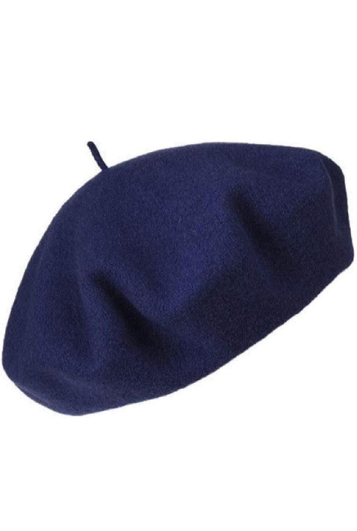 Close-up of a dark navy blue beret with a small stem on top, viewed from various angles.