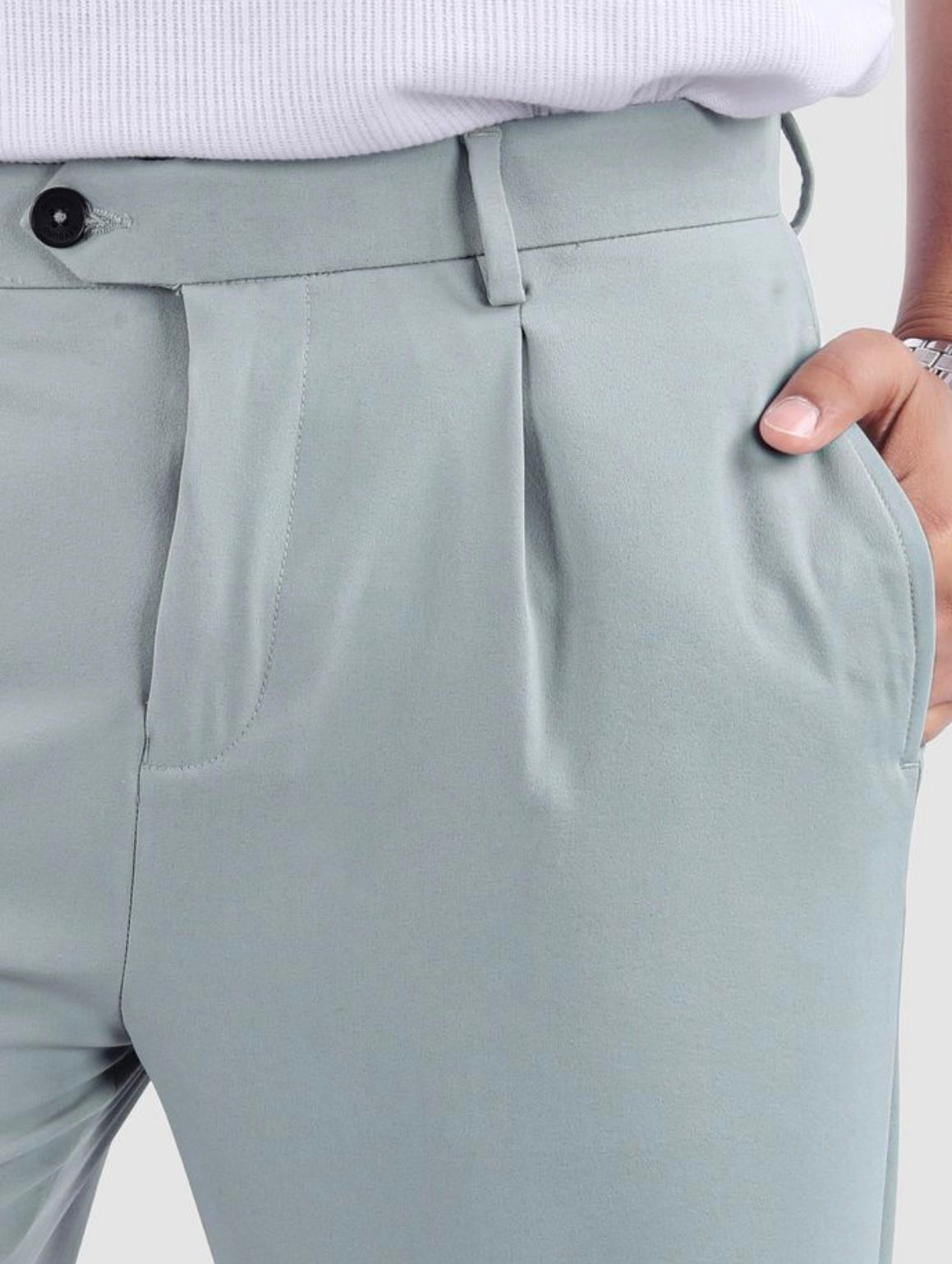 Men's sage green pleated trousers with button and pocket detail