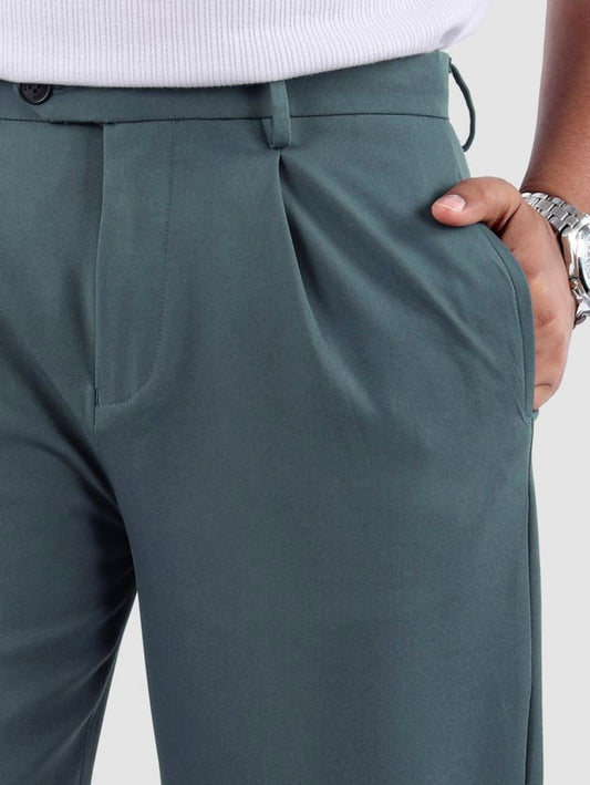Men's teal pleated wide-leg trousers shown on a model, highlighting fit and detail.